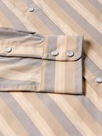 Striped snap-front western shirt in tan and gray with metal buttons and two chest flap pockets