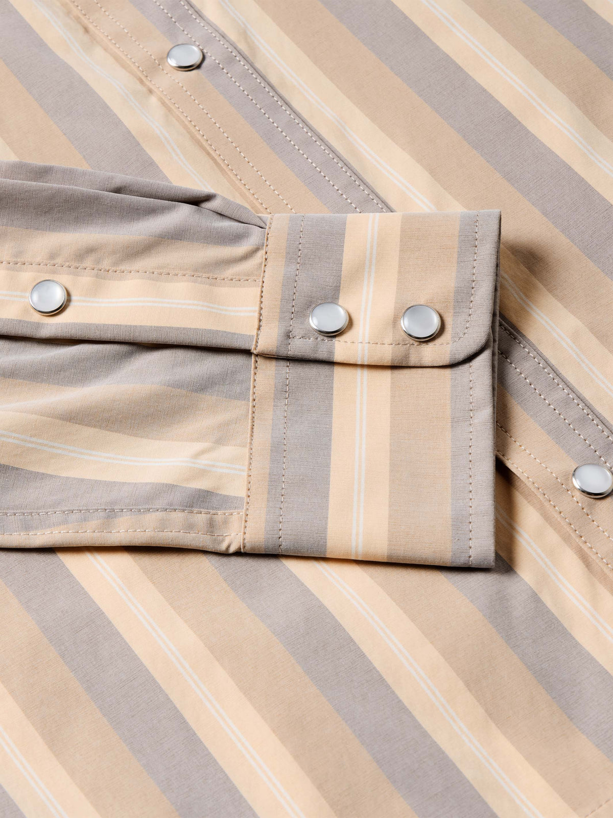 Striped snap-front western shirt in tan and gray with metal buttons and two chest flap pockets