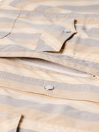 Striped western snap shirt with curved yoke and metal snap placket, logo detail