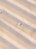 Striped snap-front western shirt placket with metal snap button and stitched accents