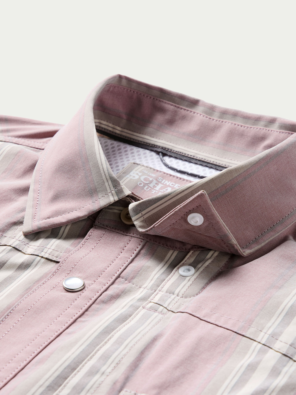 Light pink button-up shirt, open collar with inner branded lining and visible buttons