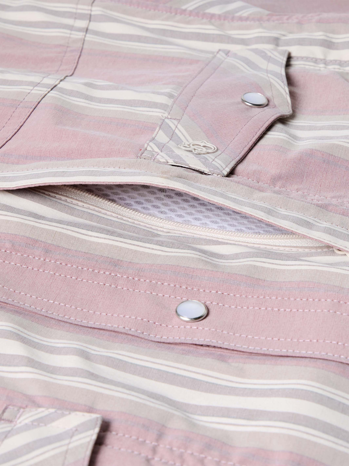 Pink striped shirt placket and button close-up with embroidered logo
