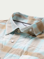 Western snap shirt collar with light blue and tan plaid, snap buttons and inner label
