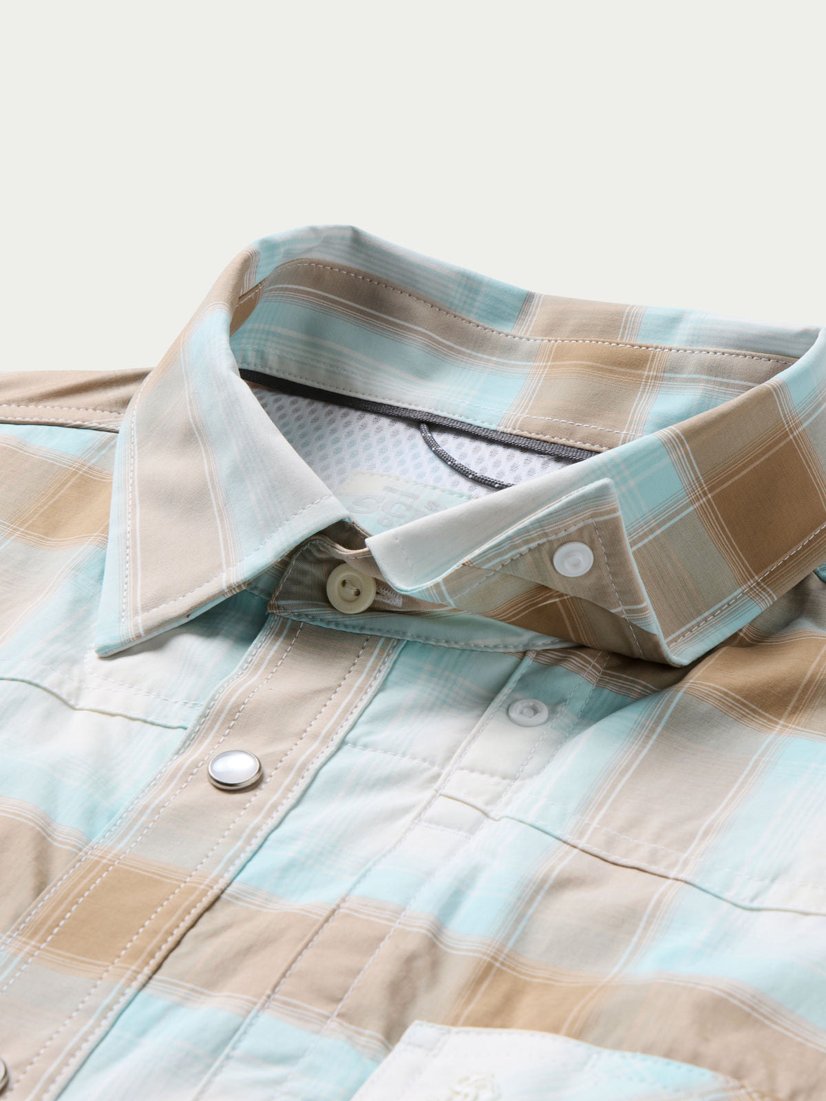 Western snap shirt collar with light blue and tan plaid, snap buttons and inner label