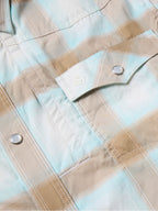 Western snap shirt with light blue and tan plaid, buttoned sleeve placket detail