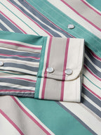 Western snap shirt detail: striped fabric yoke and teal pocket flaps with snap buttons
