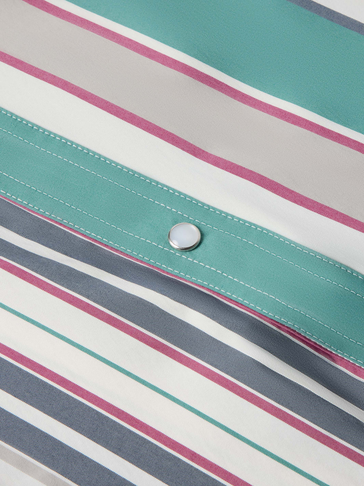 Close-up of striped western snap shirt front panel with teal button placket