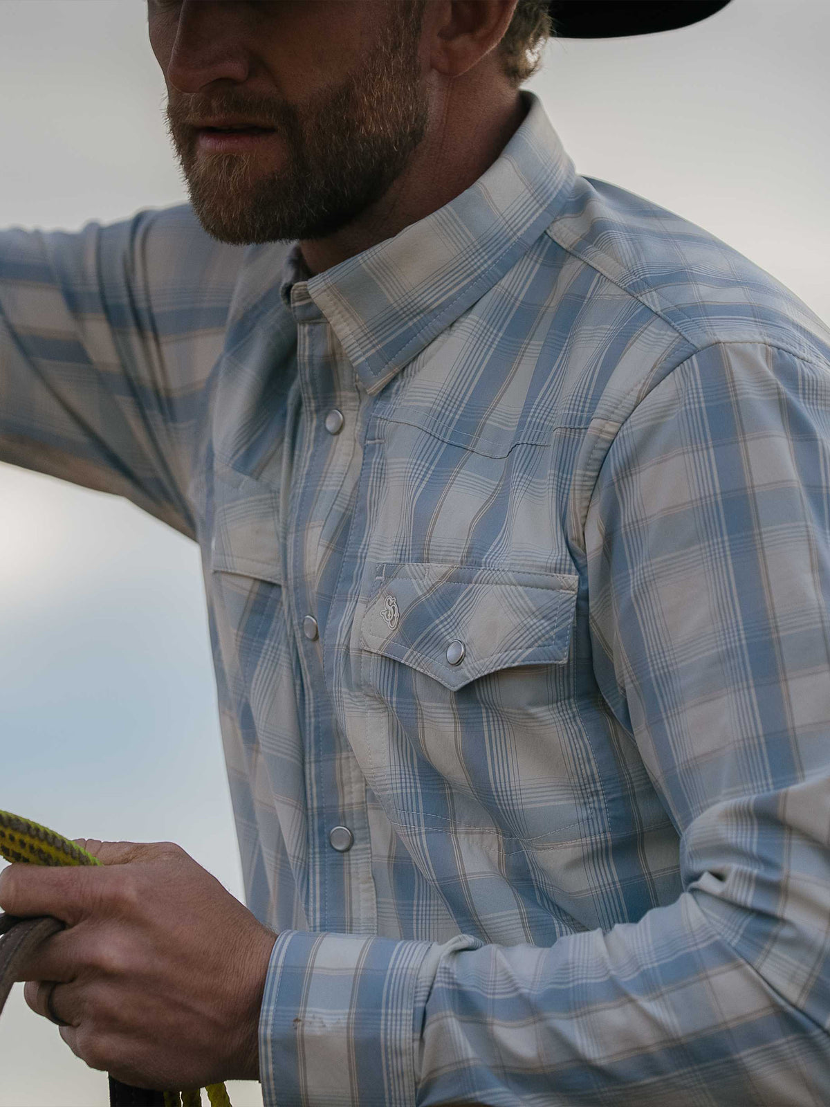 RangeTek western snap shirt close-up, light blue plaid with snap buttons and chest placket