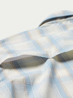 Light blue and white plaid western shirt sleeve with curved yoke seam
