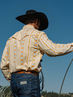 Western snap shirt worn with cream and orange Aztec stripes, long sleeves, snap front