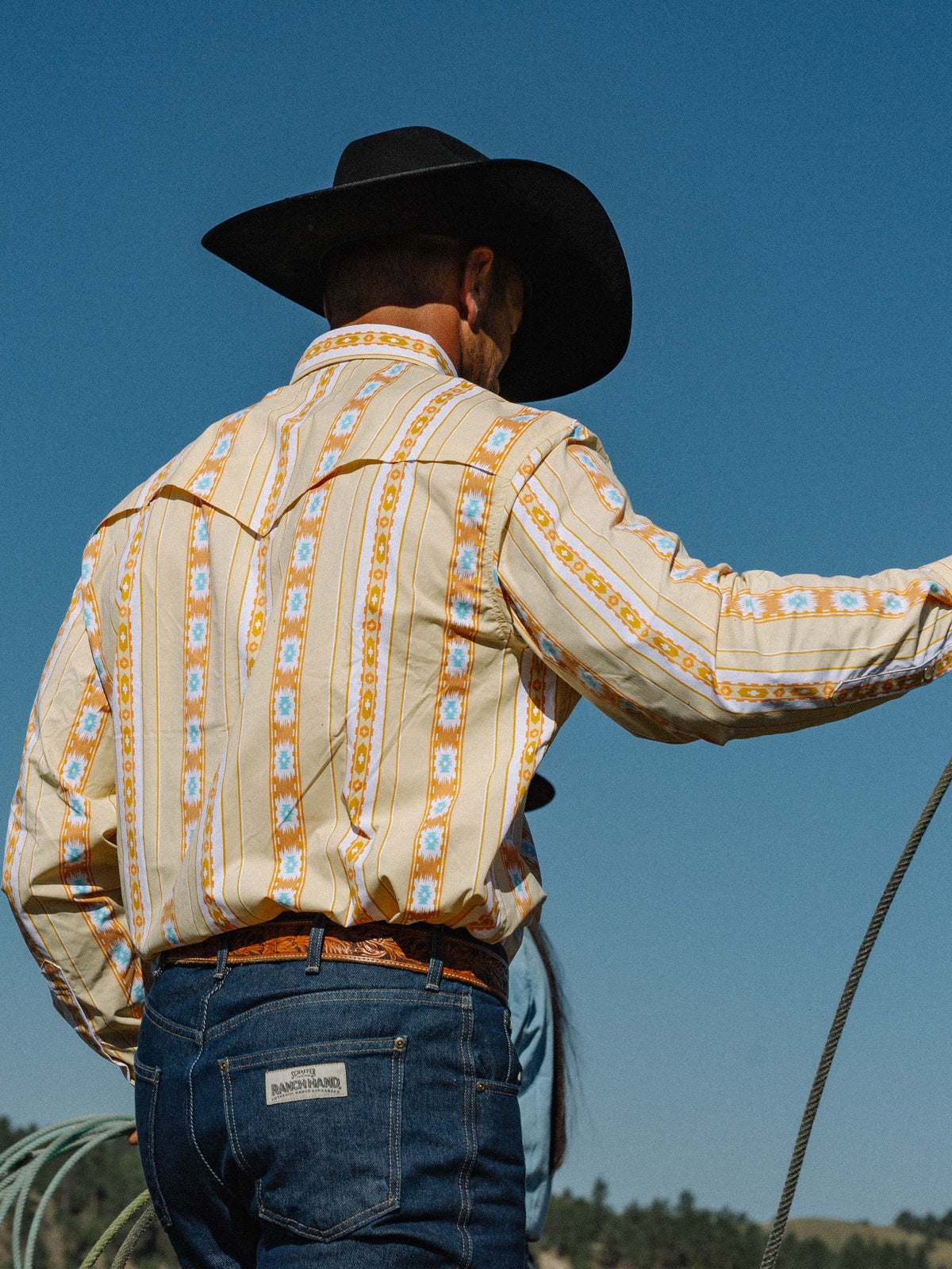Western snap shirt worn with cream and orange Aztec stripes, long sleeves, snap front