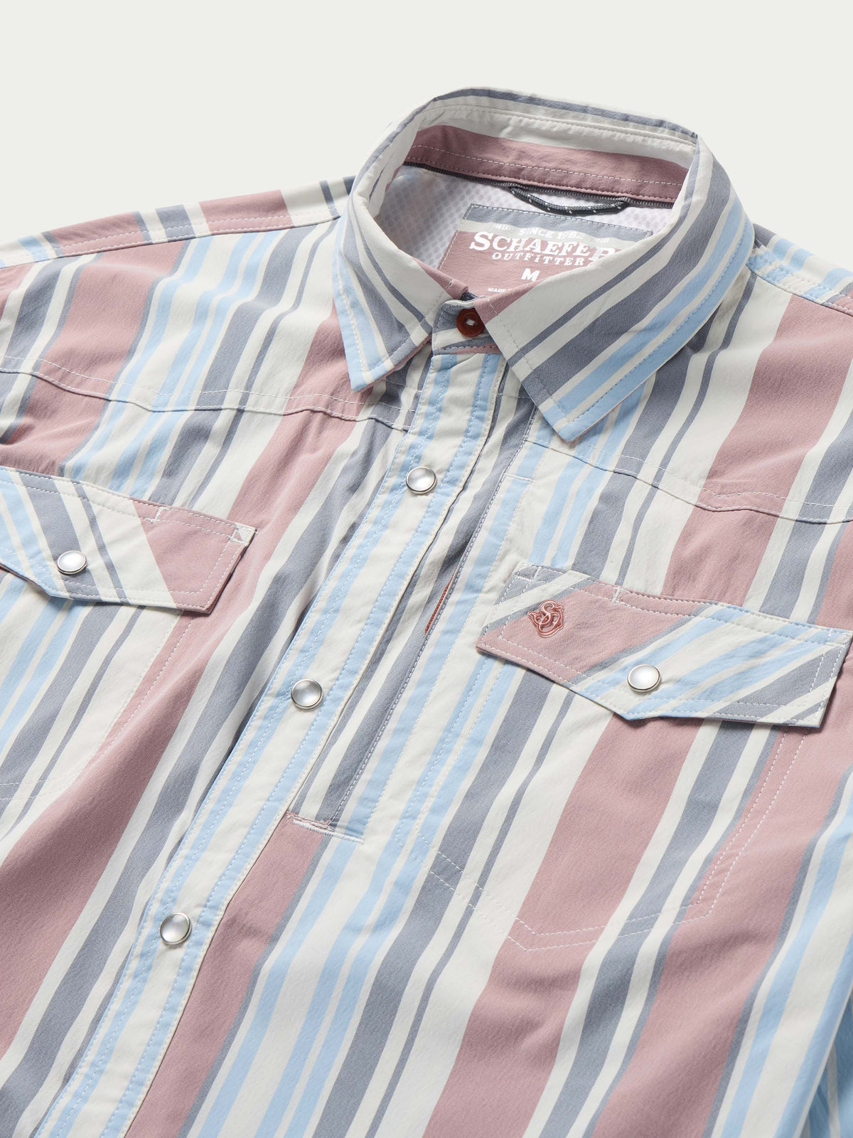 Close-up of men’s striped western snap shirt with spread collar and two chest pockets