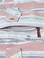 Detail of men’s striped western snap shirt showing chest pockets, snaps, and stitched placket edges