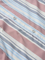 Close-up of striped western snap shirt placket with metal snaps, pink and blue