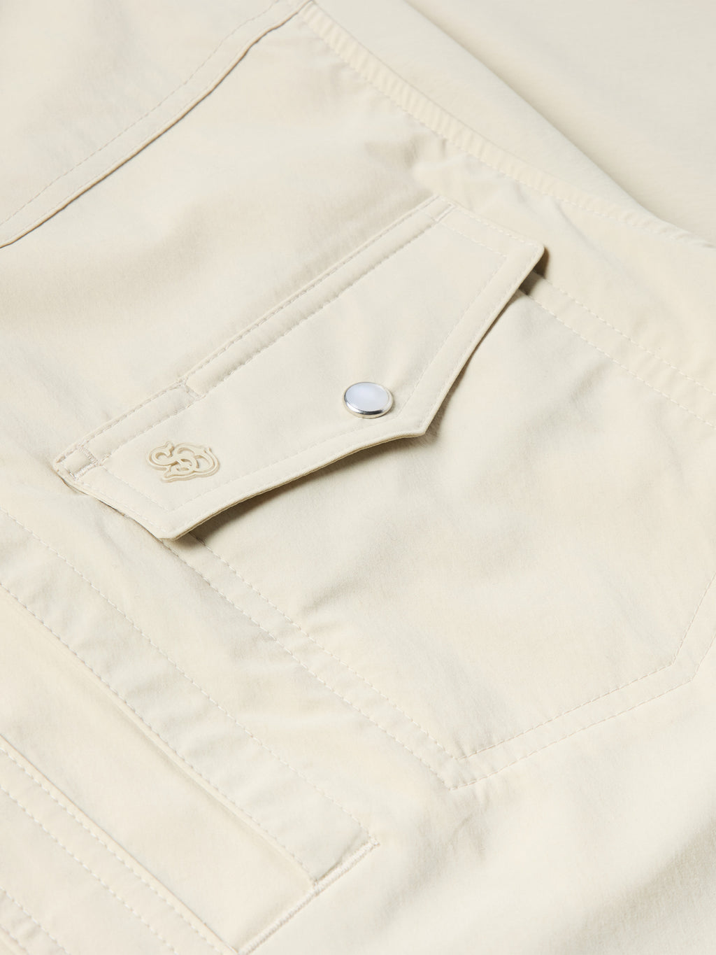 Khaki Western snap shirt chest pocket with snap tab and small stitched emblem
