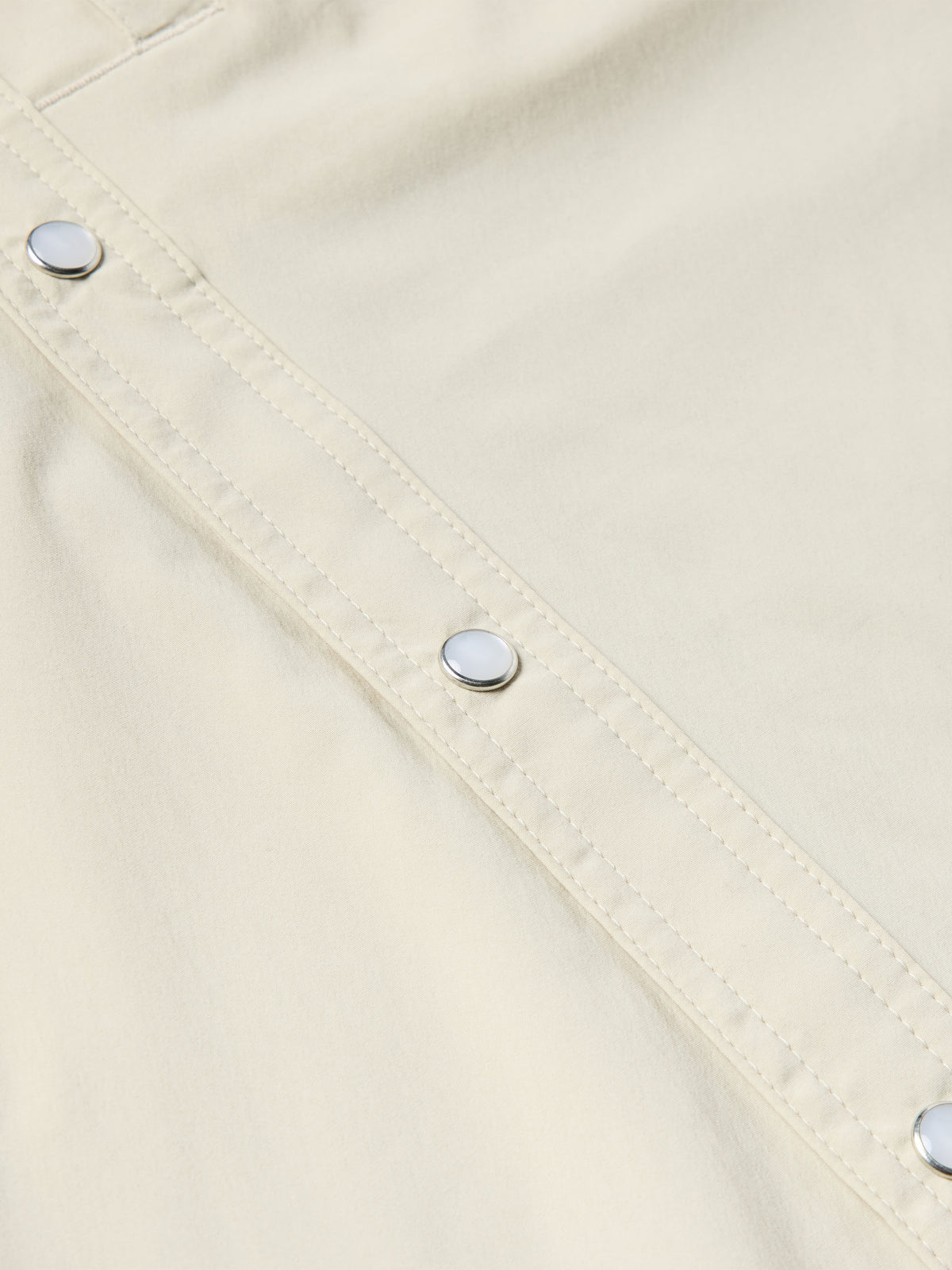 Khaki Western snap shirt with buttoned placket and diagonal stitch lines