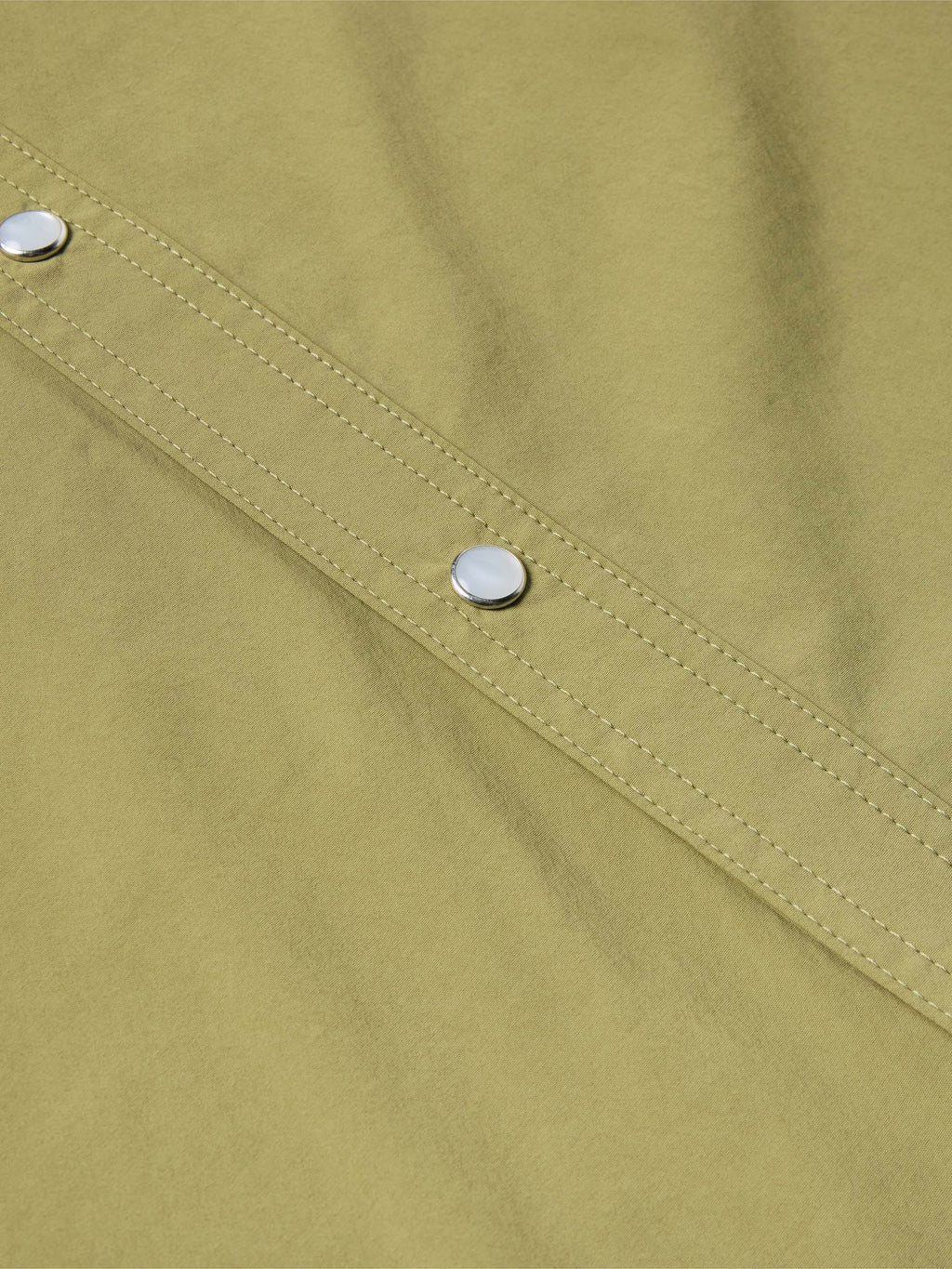 Olive short-sleeve snap western shirt close-up of button placket and stitched yoke