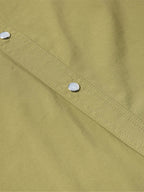 Olive short-sleeve snap western shirt close-up of button placket and stitched yoke