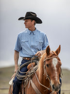Sky blue short-sleeve western snap shirt worn with cowboy hat