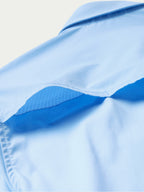 Light blue short-sleeve western snap shirt with shoulder yoke and curved seams