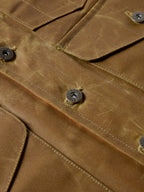 RangeWax® Mesquite vest close-up of brown fabric seams and metal snap buttons.