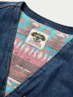 Denim vest interior tag on colorful patterned lining with button-front opening