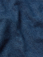 Blue denim vest fabric with visible texture and seam detailing