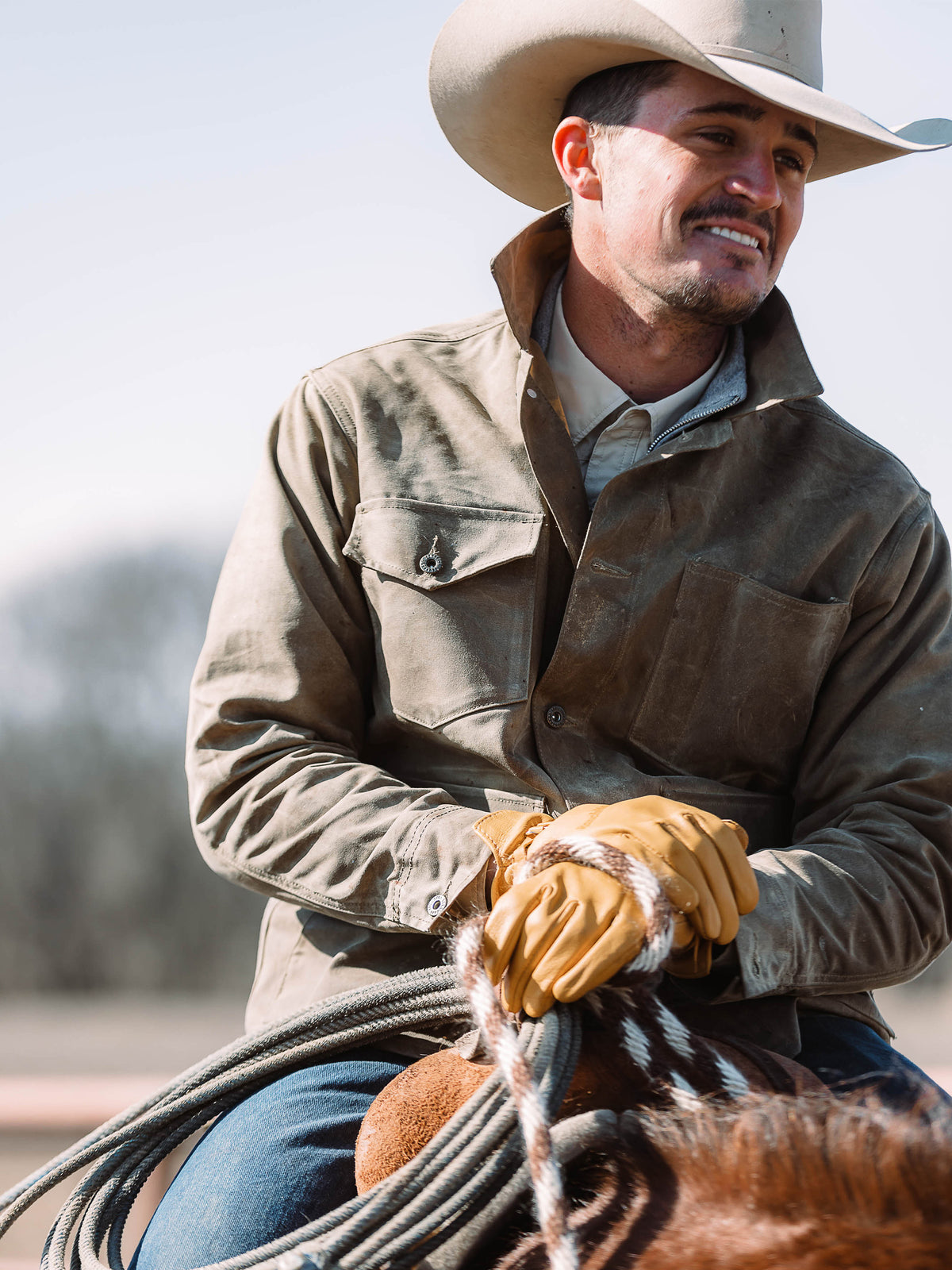 Sand brush jacket with button front and flap chest pockets, worn with gloves