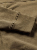 Olive cotton hoodie sleeve and ribbed cuff seam detail