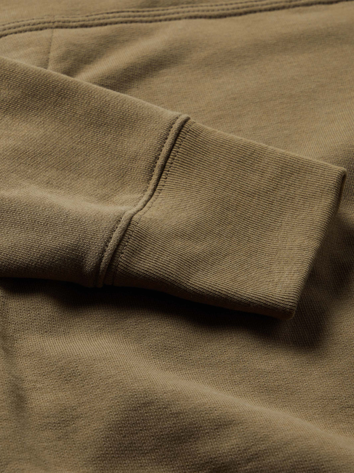 Olive cotton hoodie sleeve and ribbed cuff seam detail
