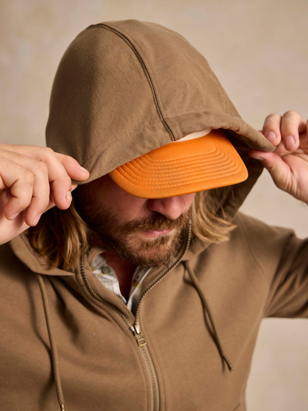 Olive cotton hoodie close-up: drawstring hood with orange interior lining