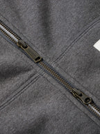 Heather charcoal zipper and seam detail with metal zipper pull and stitched edges