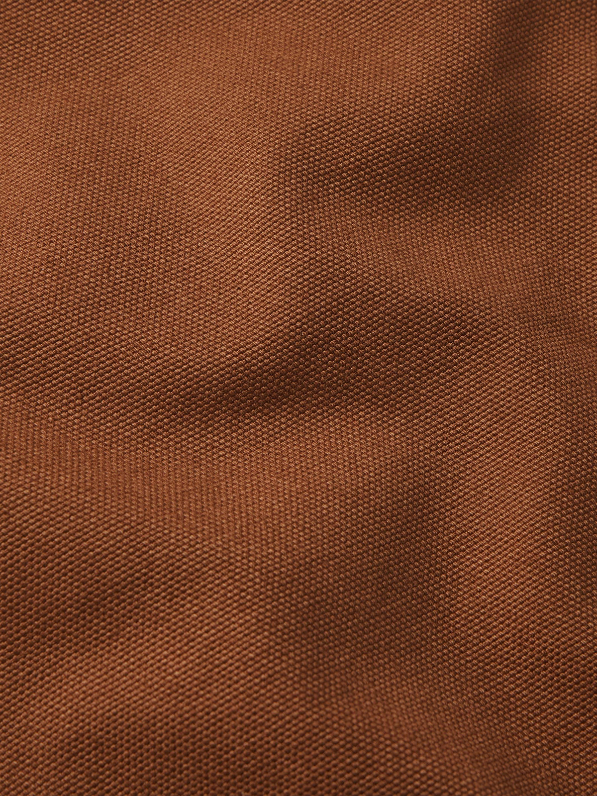 Russet canvas fabric texture close-up, showing fine woven pattern