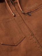 Russet canvas jacket close-up of front zipper and branded chest label