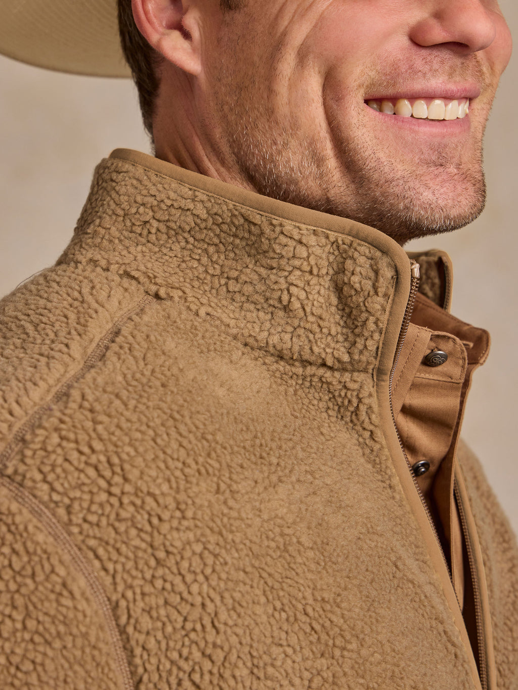 Taupe fleece jacket collar detail with zipper and snap placket