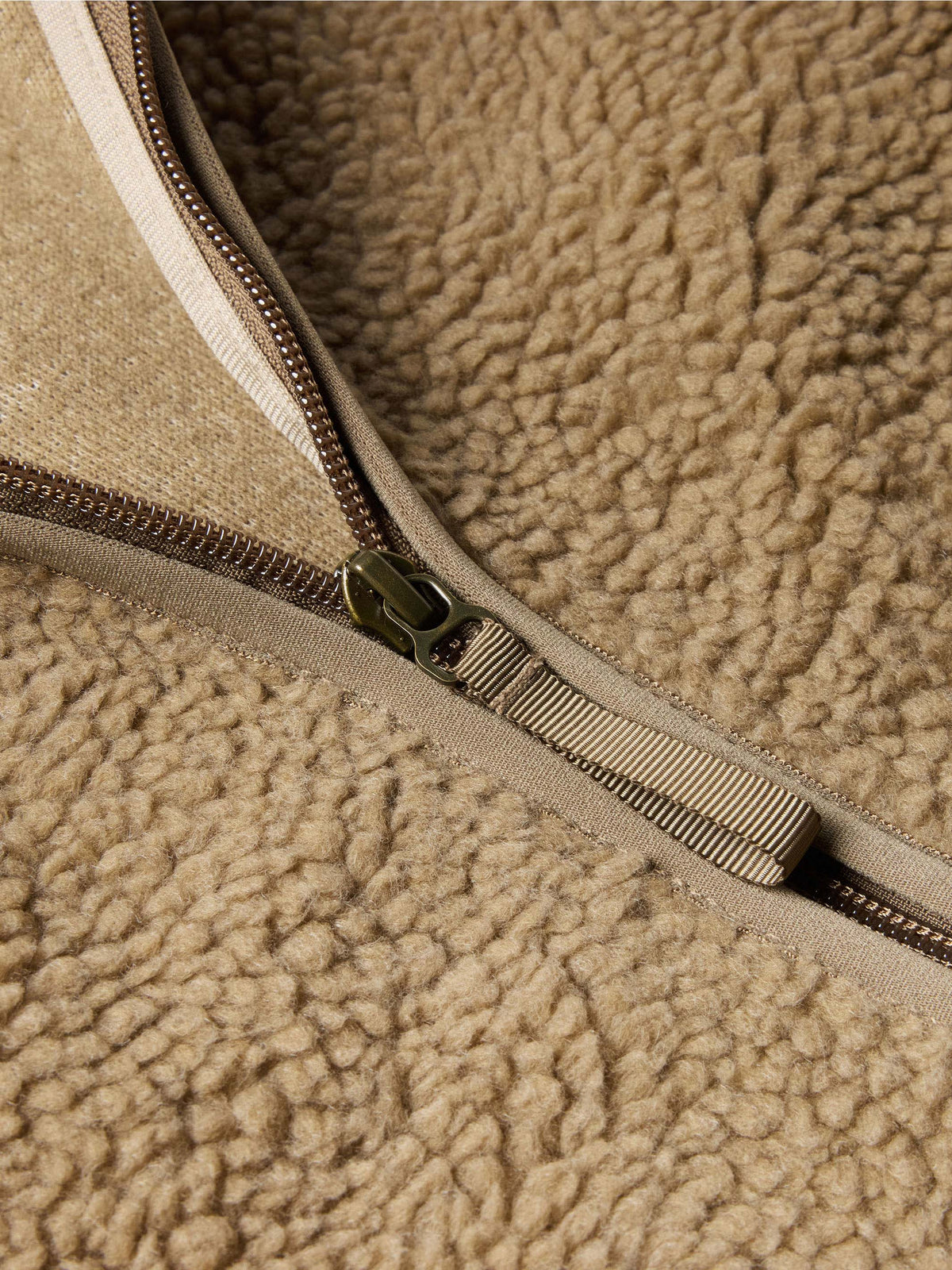 Taupe zip track with metal zipper pull on fleece jacket