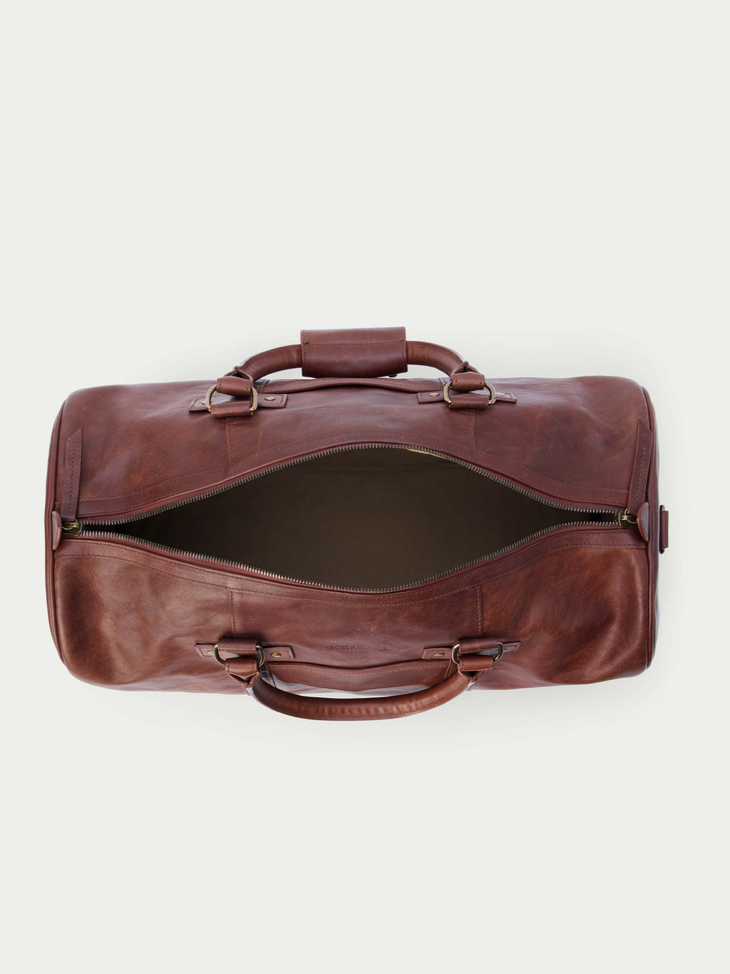 Russet leather weekender duffel bag open with dual top handles and side buckles.