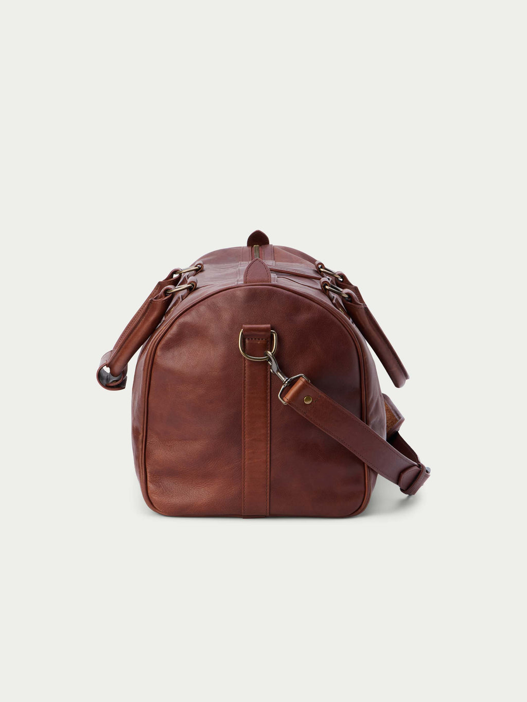 Russet leather weekender duffel bag with rear strap attachments and top handle.