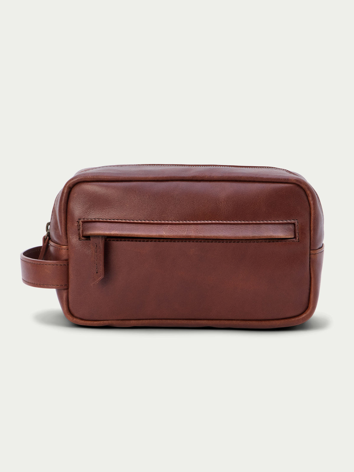 Russet leather dopp kit with front zip pocket and attached leather carry strap