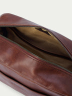 Russet leather dopp kit with zippered interior pocket and fabric lining