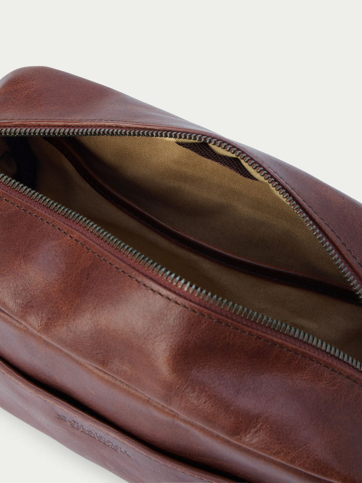 Russet leather dopp kit with zippered interior pocket and fabric lining