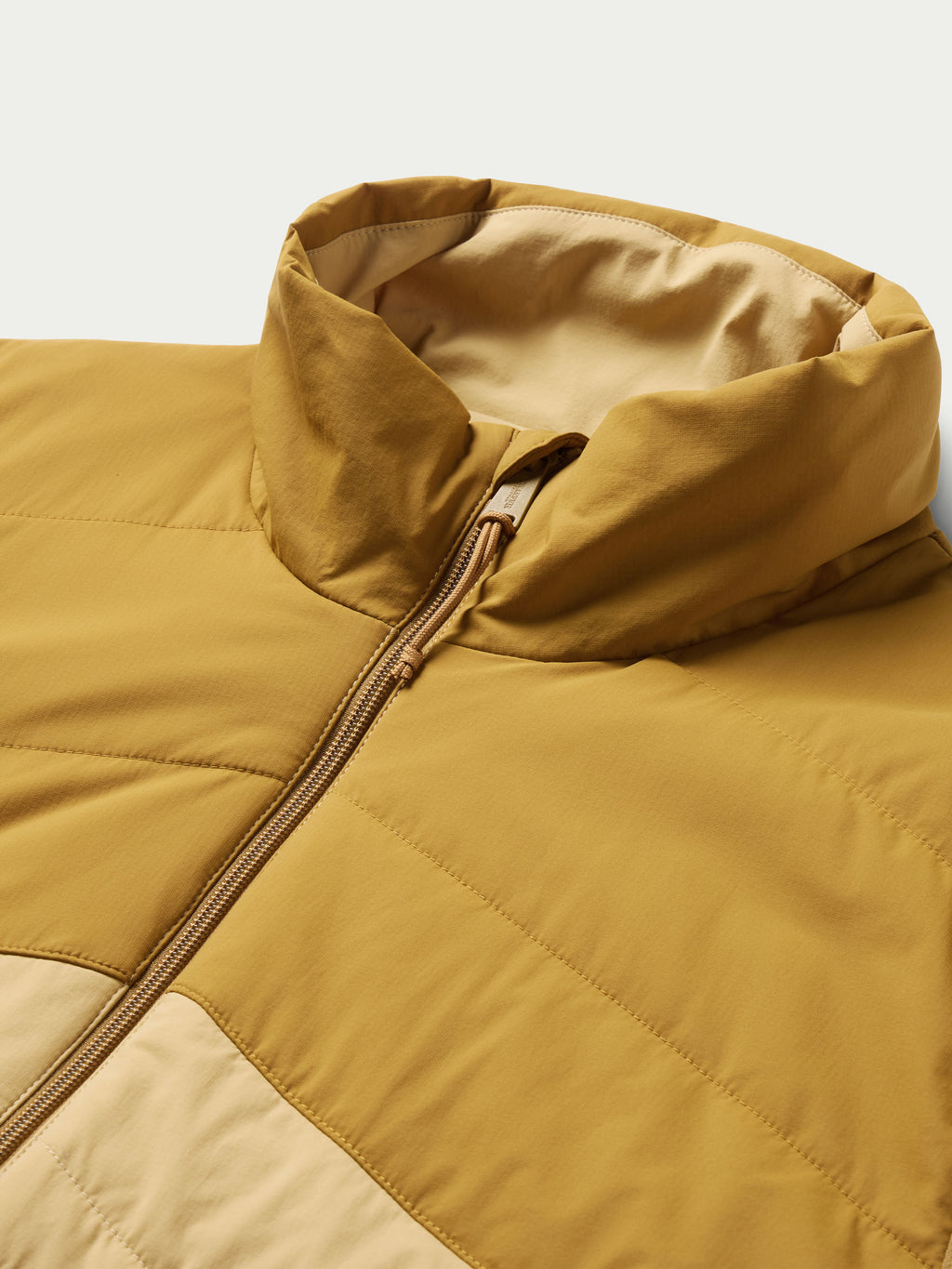 Tan vest close-up of full-zip hood collar and quilted diamond panels