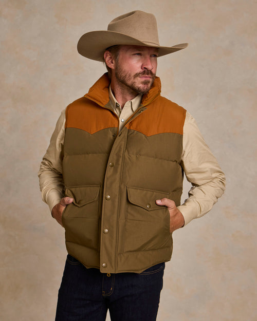 Men's down vest in cedar and olive with snap front, chest pockets, and quilted insulation