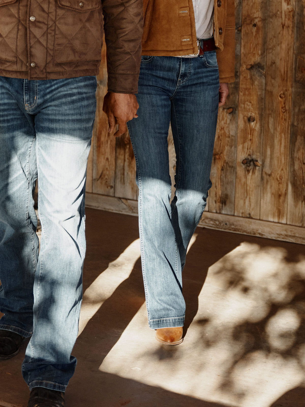 Medium-wash straight-leg jeans on model, five-pocket style with belt loops.