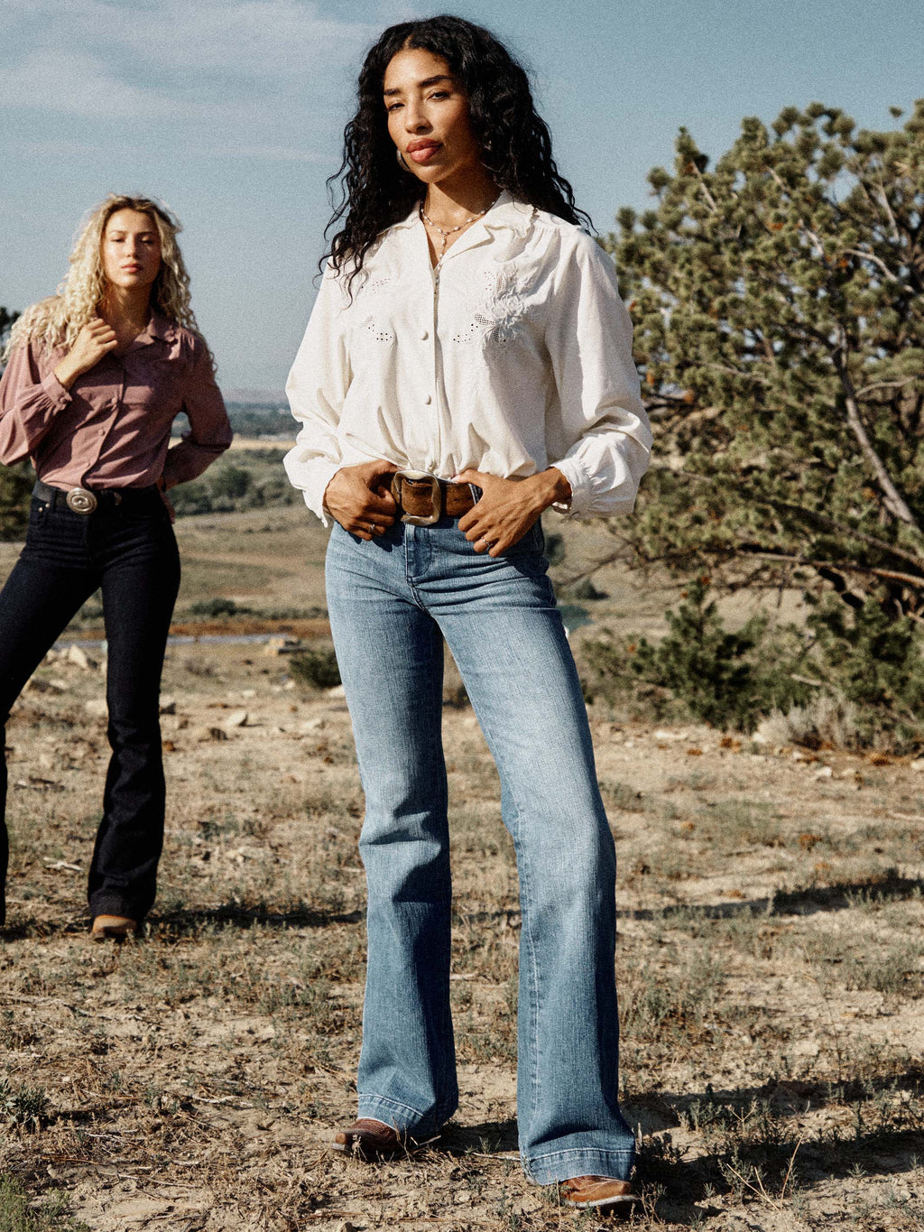 Medium wash denim jeans with wide straight leg and classic five-pocket styling