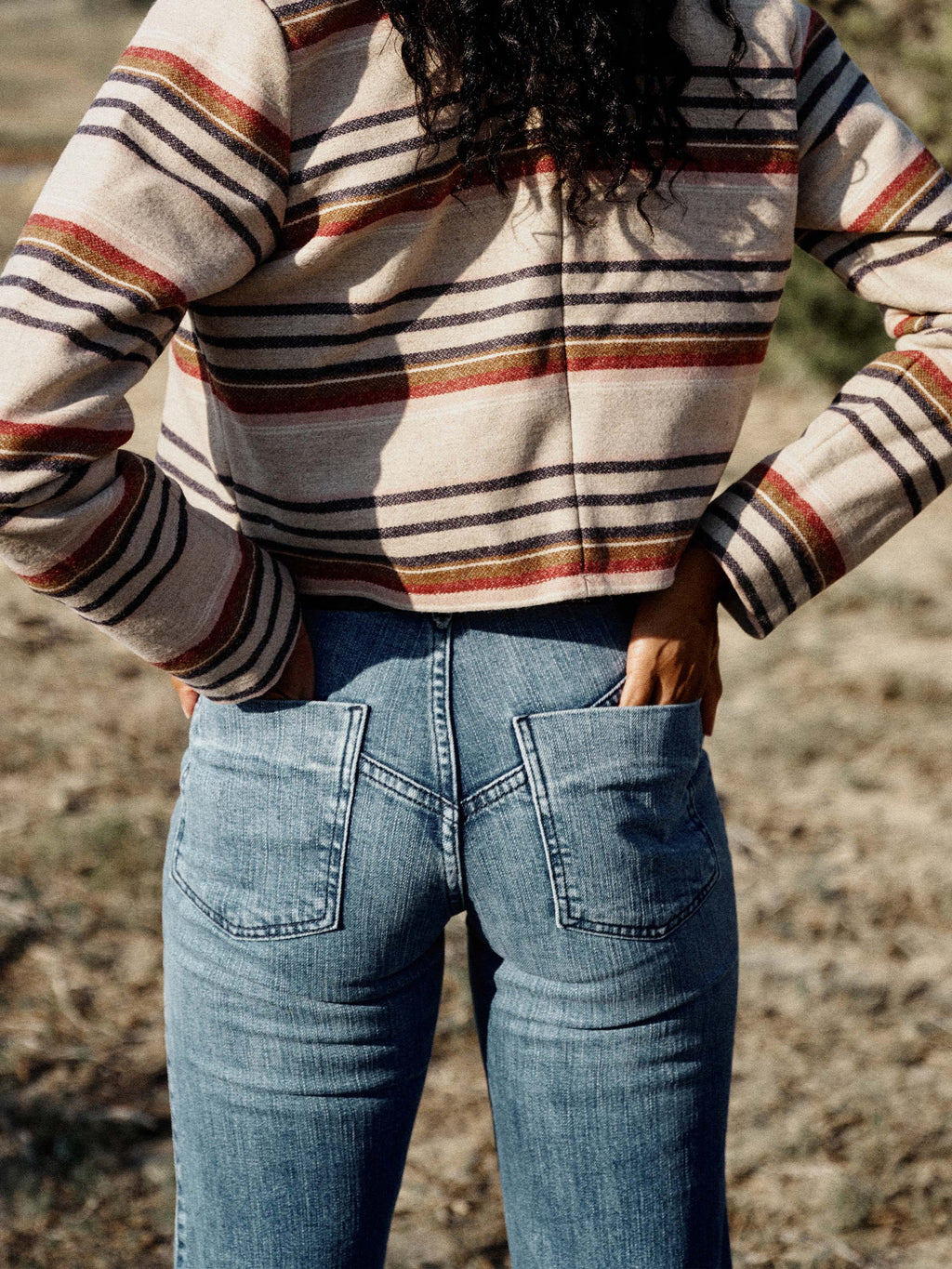 Medium wash denim jeans with straight wide leg and stitched rear pockets
