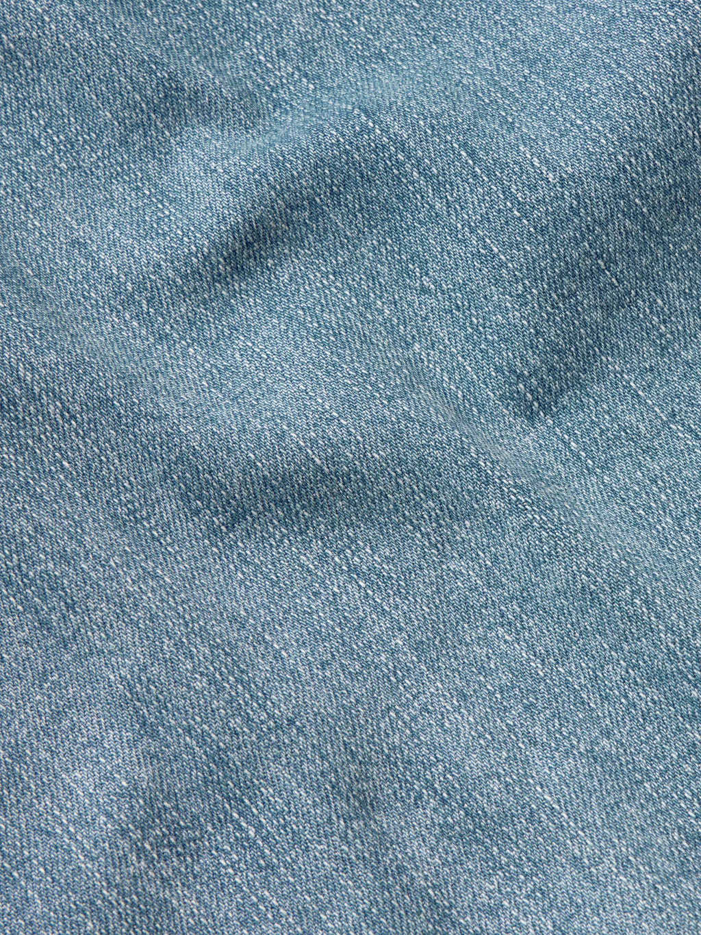 Medium wash blue denim fabric texture close-up