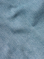 Medium wash blue denim fabric texture close-up