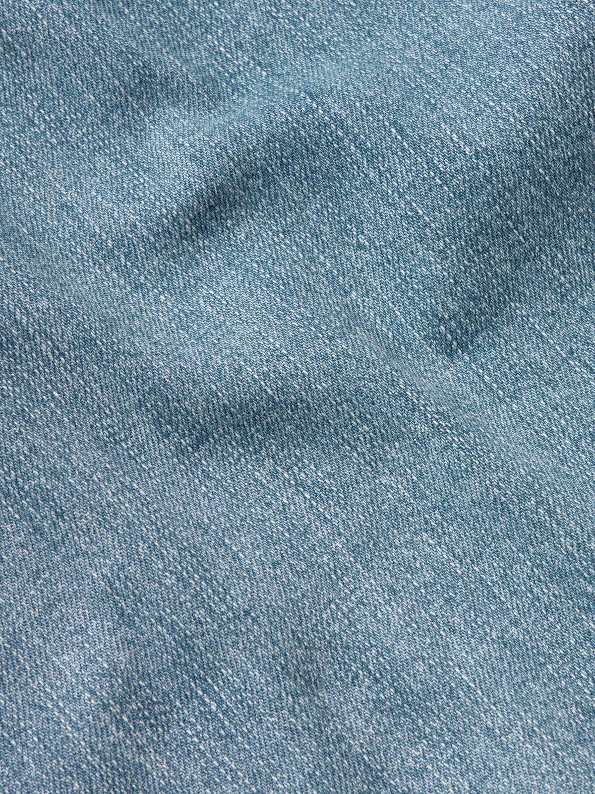 Medium wash blue denim fabric texture close-up