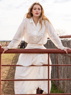 White tiered midi skirt with gathered waist and lace border at hem